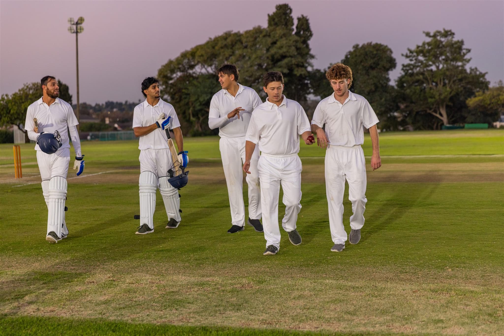 Local cricket team at dusk